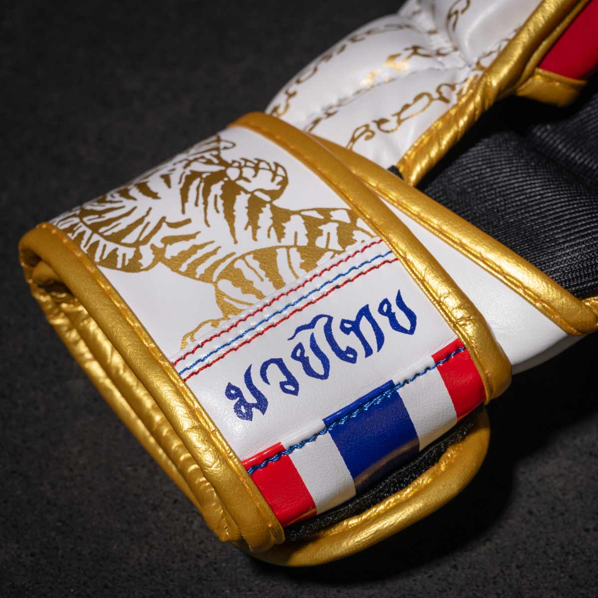 Phantom Muay Thai Handschuhe für Thaiboxen und MMA Sparring, Wettkampf und Training. Im traditionellen Sak Yant Design und der Farbe Weiß/Gold.