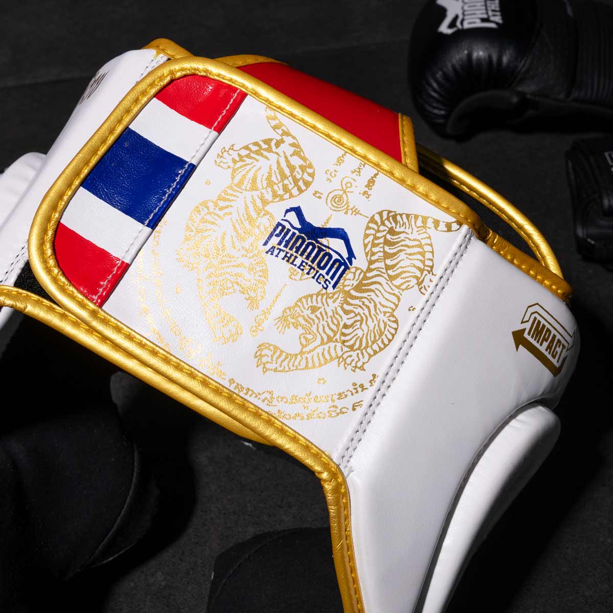 Phantom Muay Thai Kopfschutz für Thaiboxen und MMA Sparring, Wettkampf und Training. Im traditionellen Sak Yant Design und der Farbe Blau/Rot.